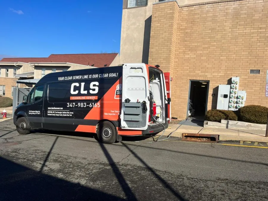 Clearline Sewer van parked in front of a commercial building on a service call